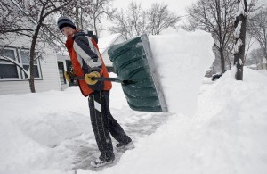 Mike Flynn shovels snow Tuesday, March 5, 2013, in Minneapolis as a winter storm dumped snow on much of the state. Tens of thousands of Minnesota students got a day off Tuesday as the second day of a slow-moving snowstorm made travel difficult across much of the region. (AP Photo/Jim Mone)