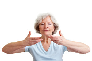 Relaxed senior woman doing some breathing exercises